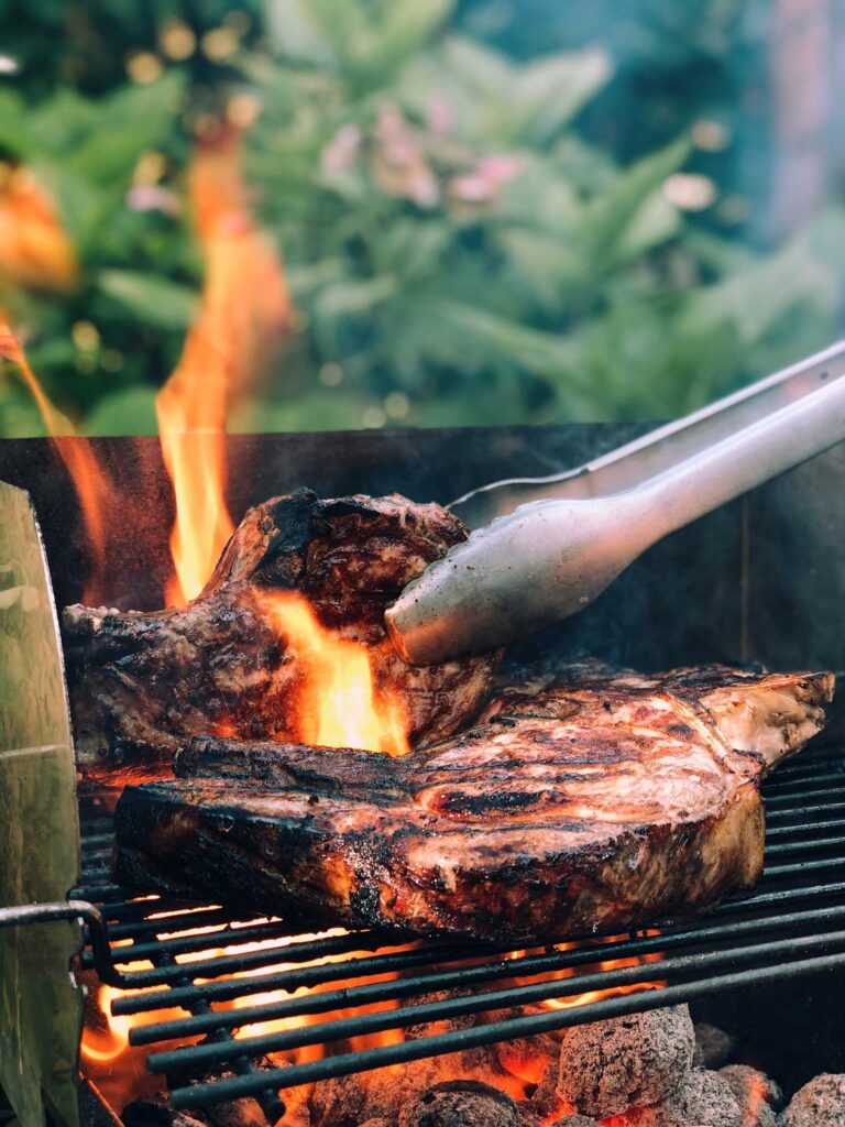 Photo of meat being prepared on a grill