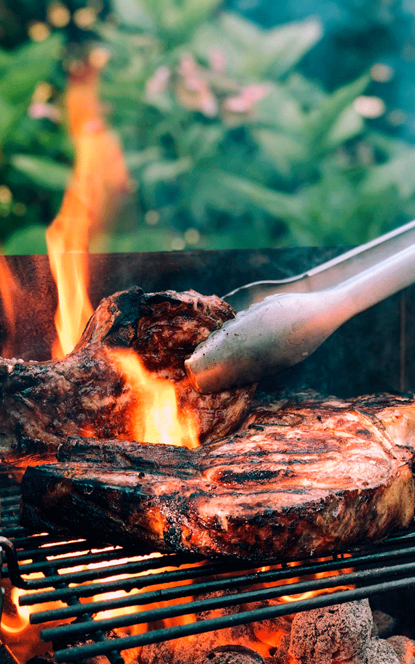Image of meat being prepaired on the grill.